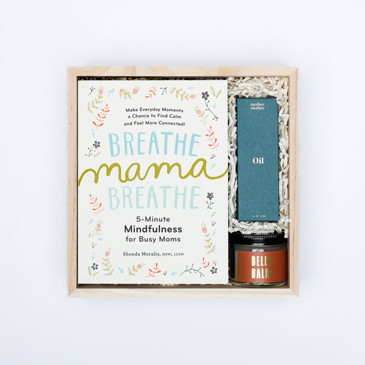 Gift set with 'Breathe Mama Breathe' book and wellness items on a white background