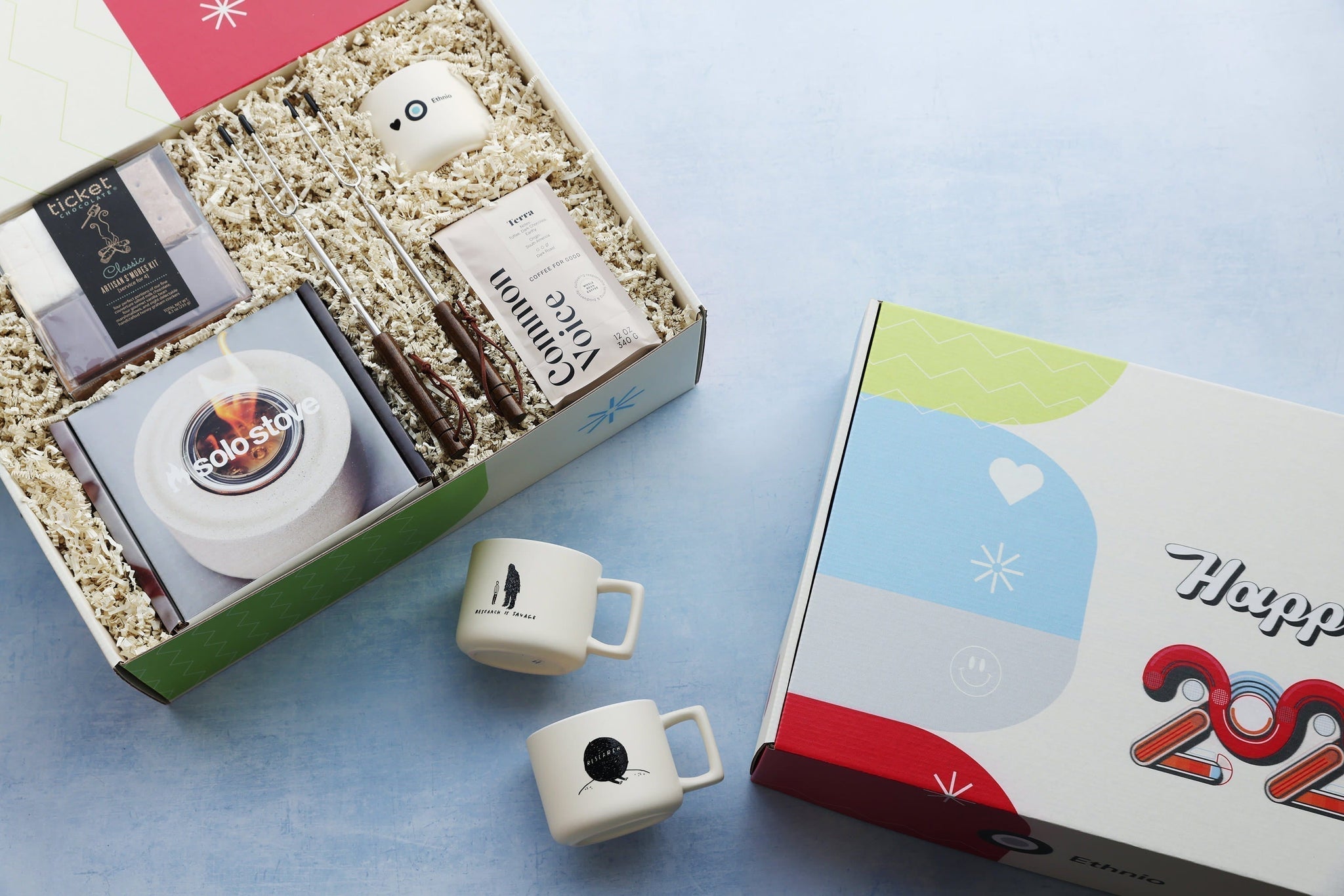 A gift set that includes fun and functional items like s'mores and coffee, with branded mugs and custom packaging.