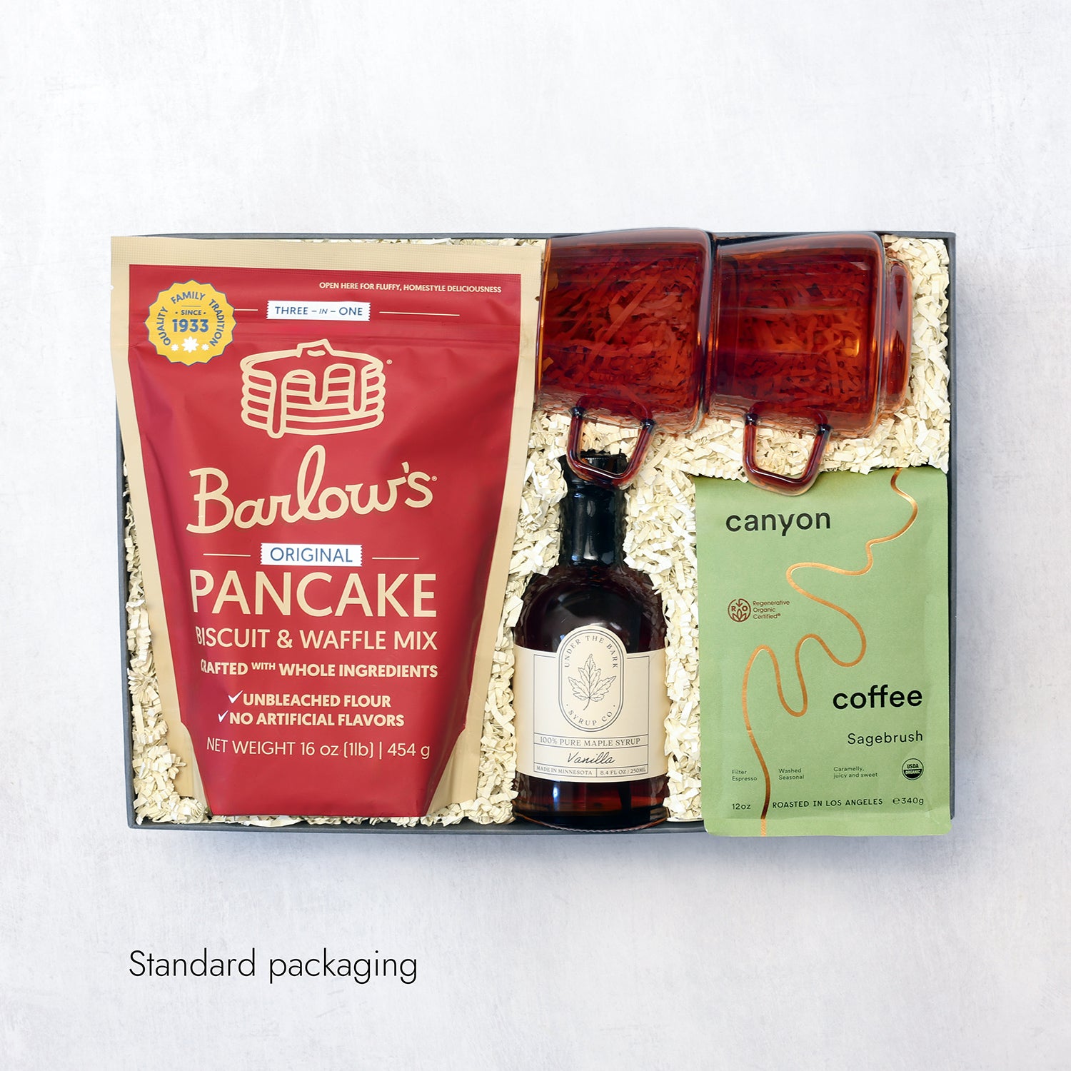Gift set with Barlow's pancake mix, coffee, and syrup on a white background