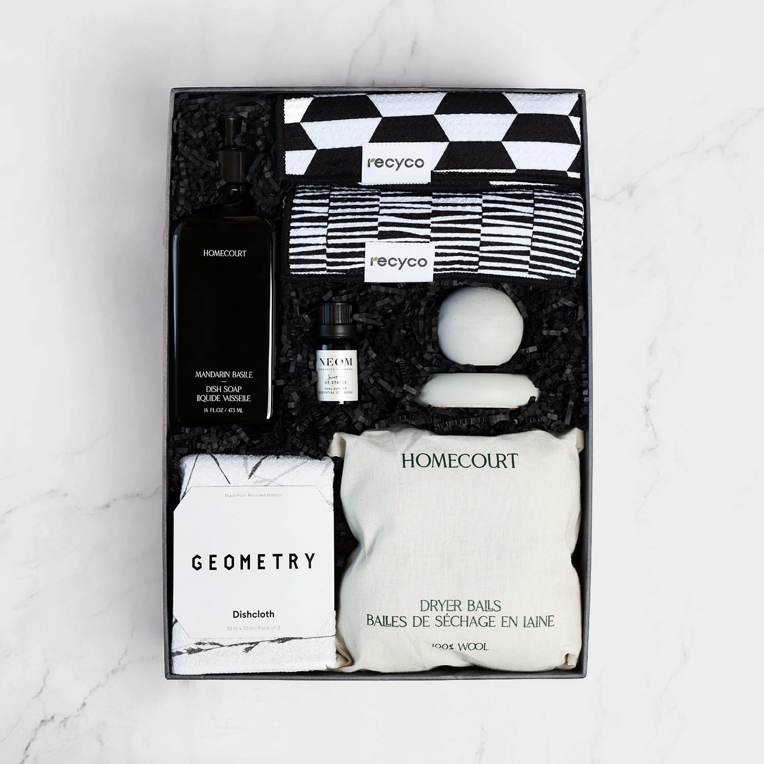 Set of black and white eco-friendly home cleaning products in a gift box.