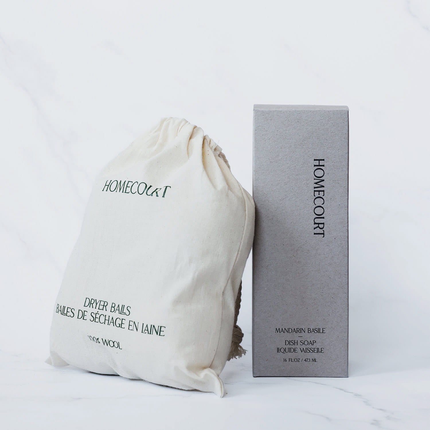 Homecourt dryer balls and dish soap in packaging on a white background