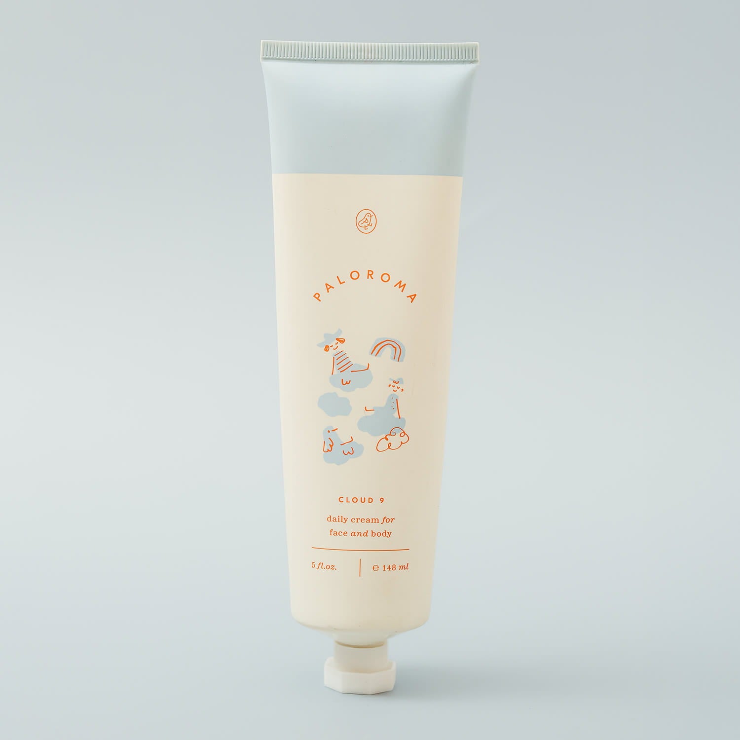 Tube of lotion with branding on a light gray background