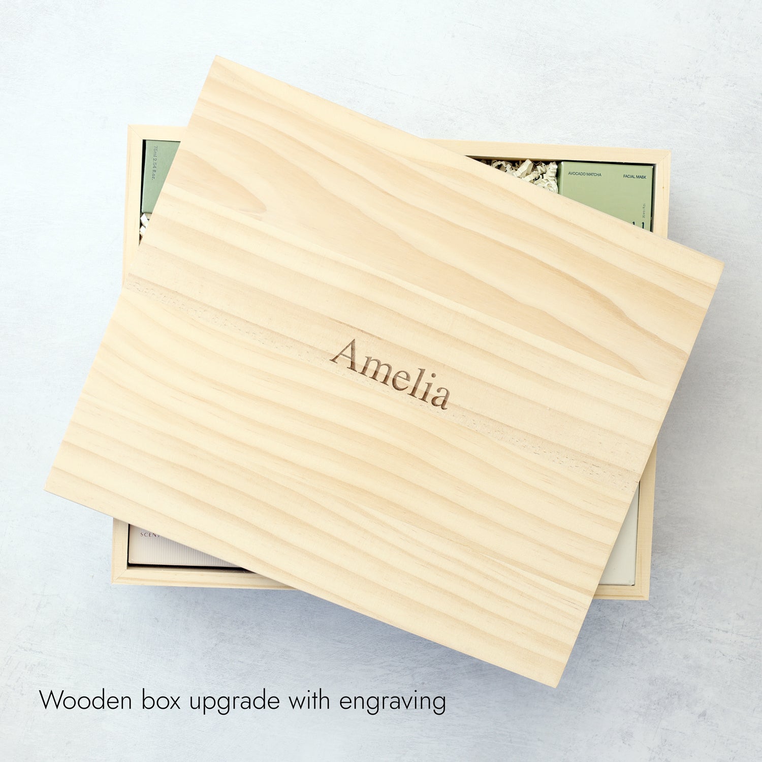 a wooden gift box with name engraved on the lid.